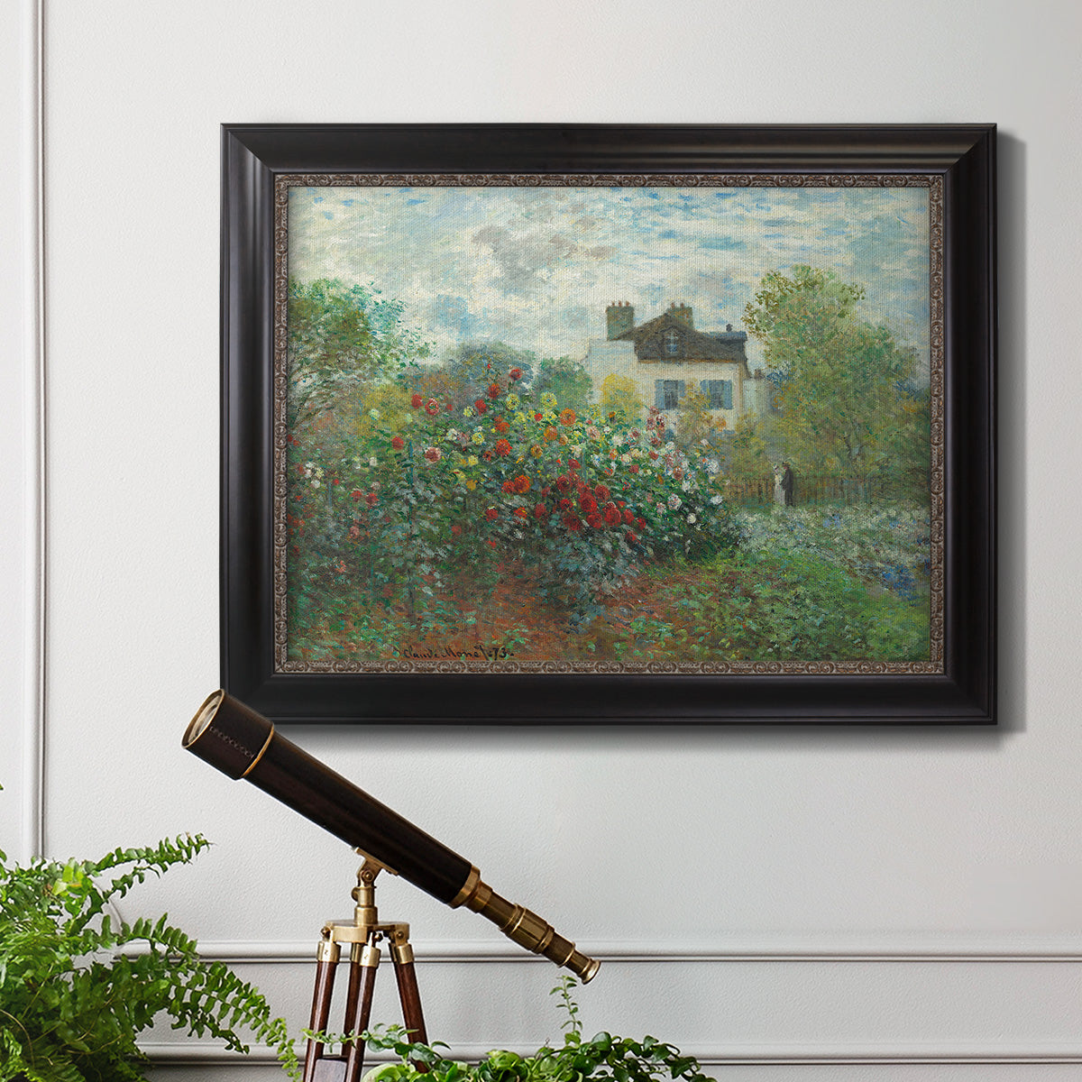 Impressionist garden landscape at Argenteuil by Claude Monet in an ornate black frame with gilded inner detail displayed in a light-toned interior setting.