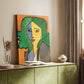 Canvas art print of a stylized face with geometric shapes and vivid tones styled in a home decor setting.