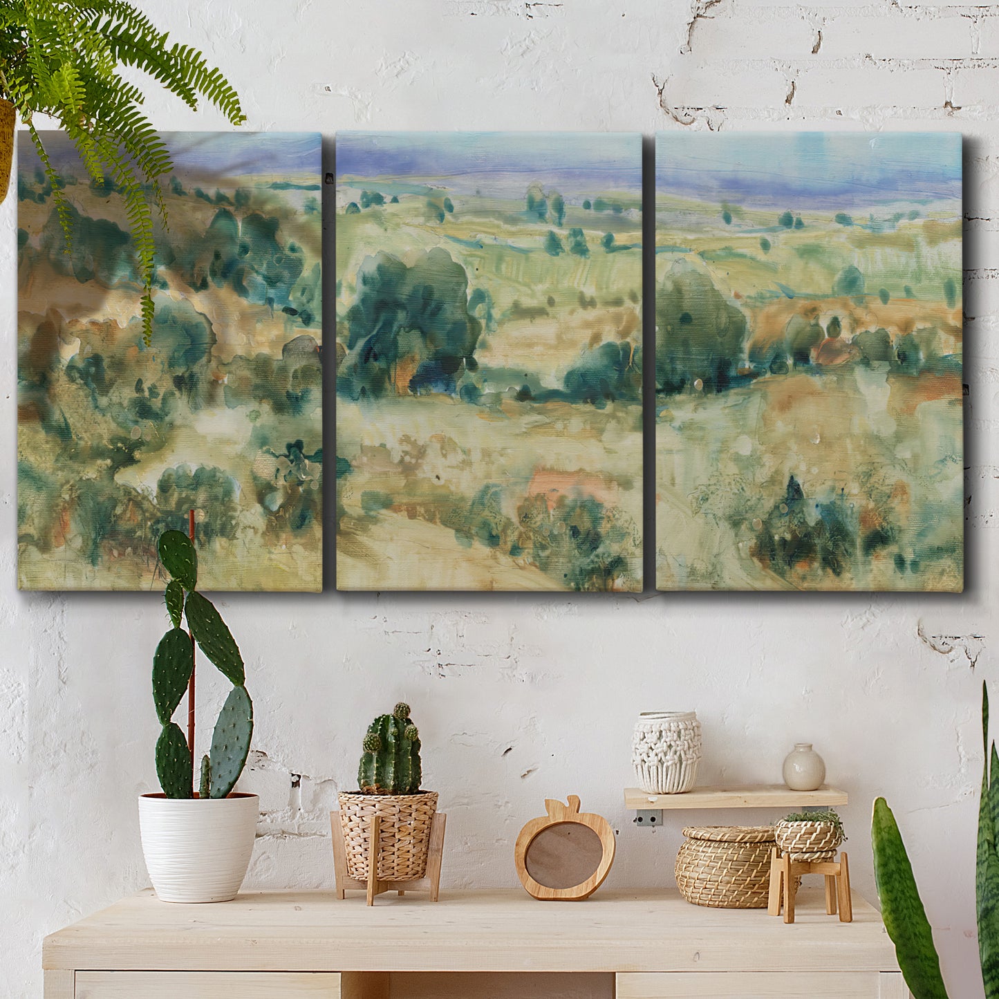 Three-panel canvas wall art featuring lavender sky over quiet landscape, displayed in a boho-chic entryway above a console table.