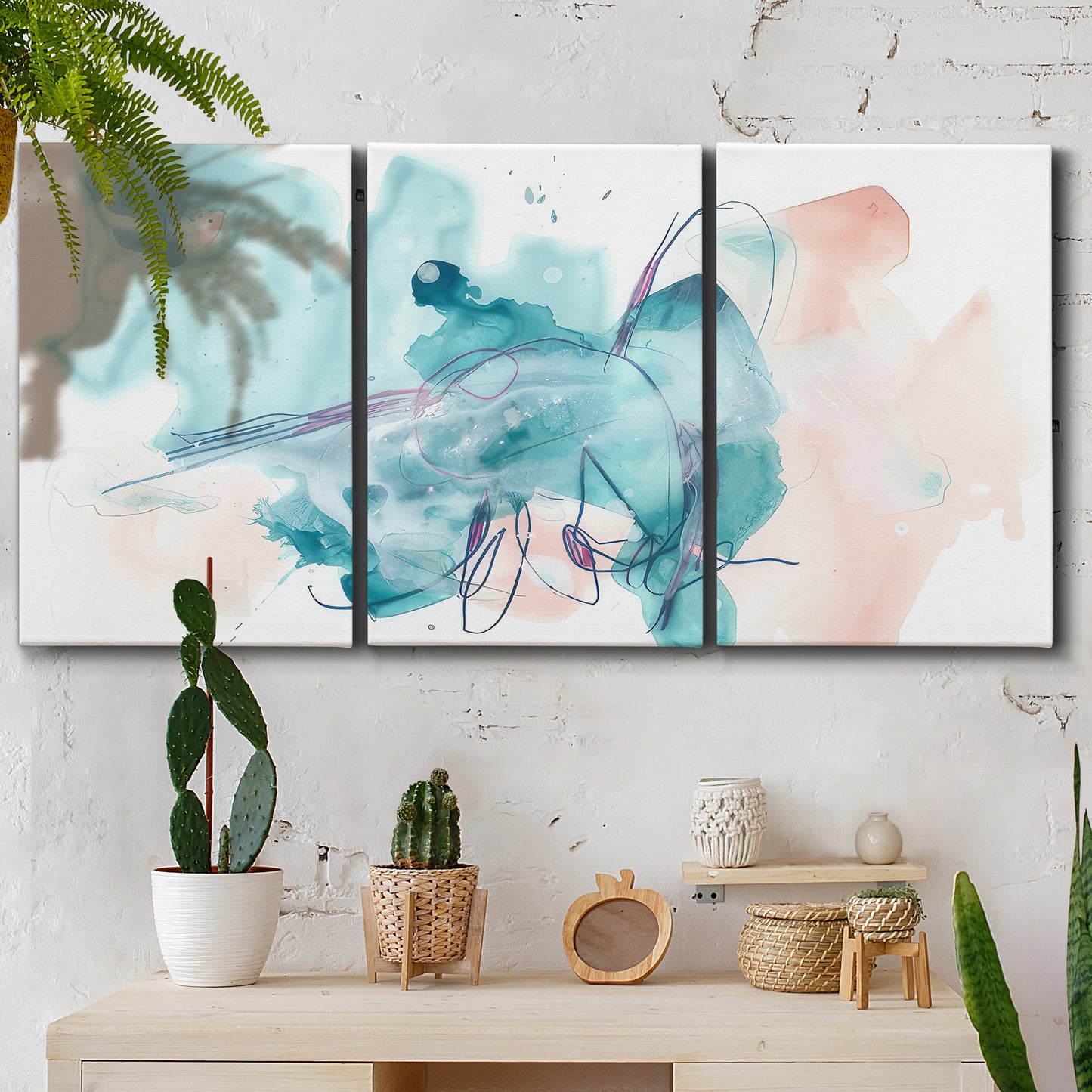 Three-panel canvas wall art featuring soft abstract watercolor forms, displayed in a boho-chic entryway above a console table.