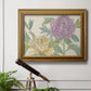 Contemporary peony flower illustration in an ornate traditional gold frame displayed in a light-toned interior setting.