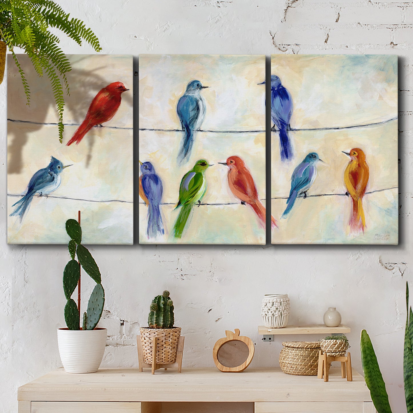 Three-panel canvas wall art featuring whimsical animal chatter illustration, displayed in a boho-chic entryway above a console table.