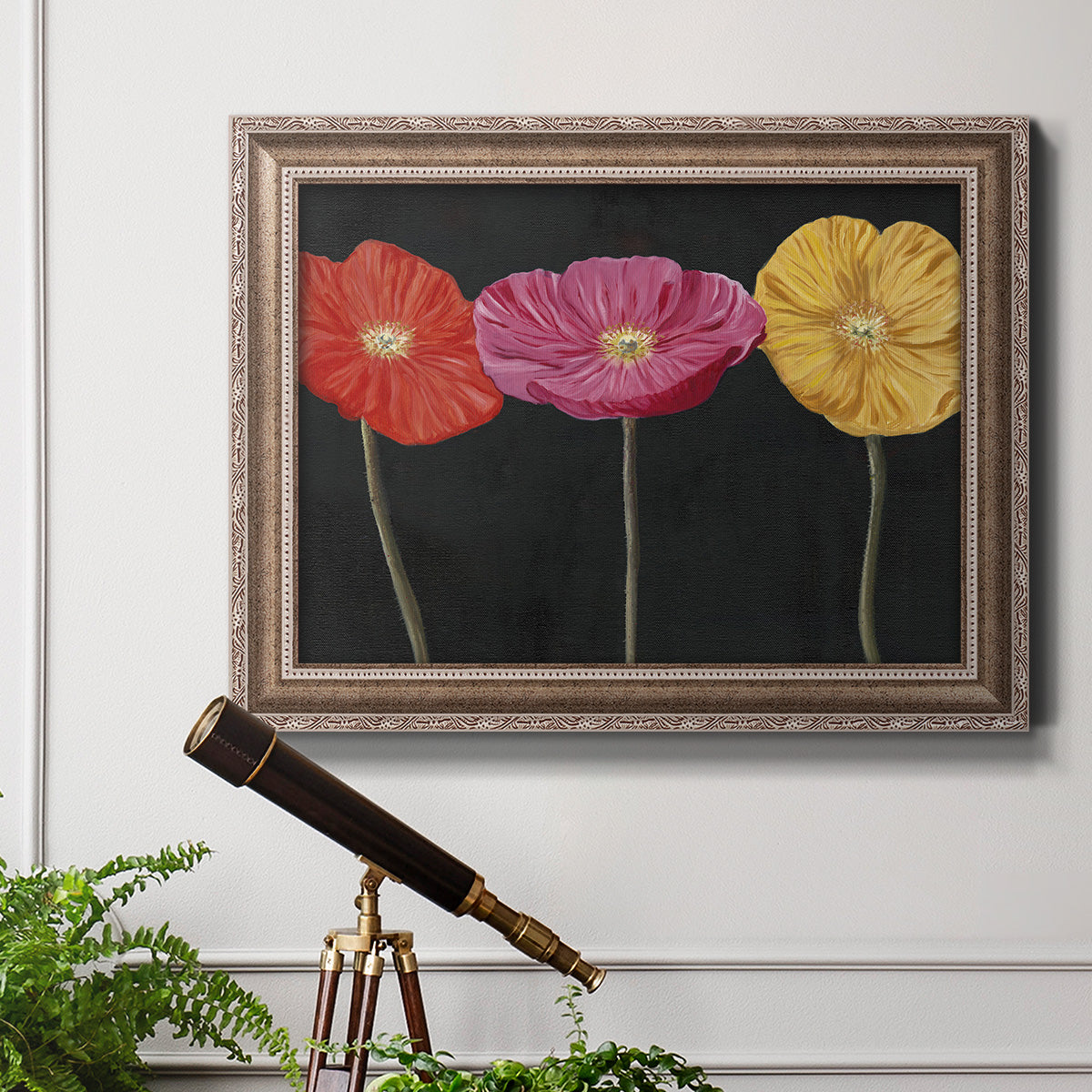 Contemporary poppy flower artwork in an ornate traditional silver frame displayed in a light-toned interior setting.