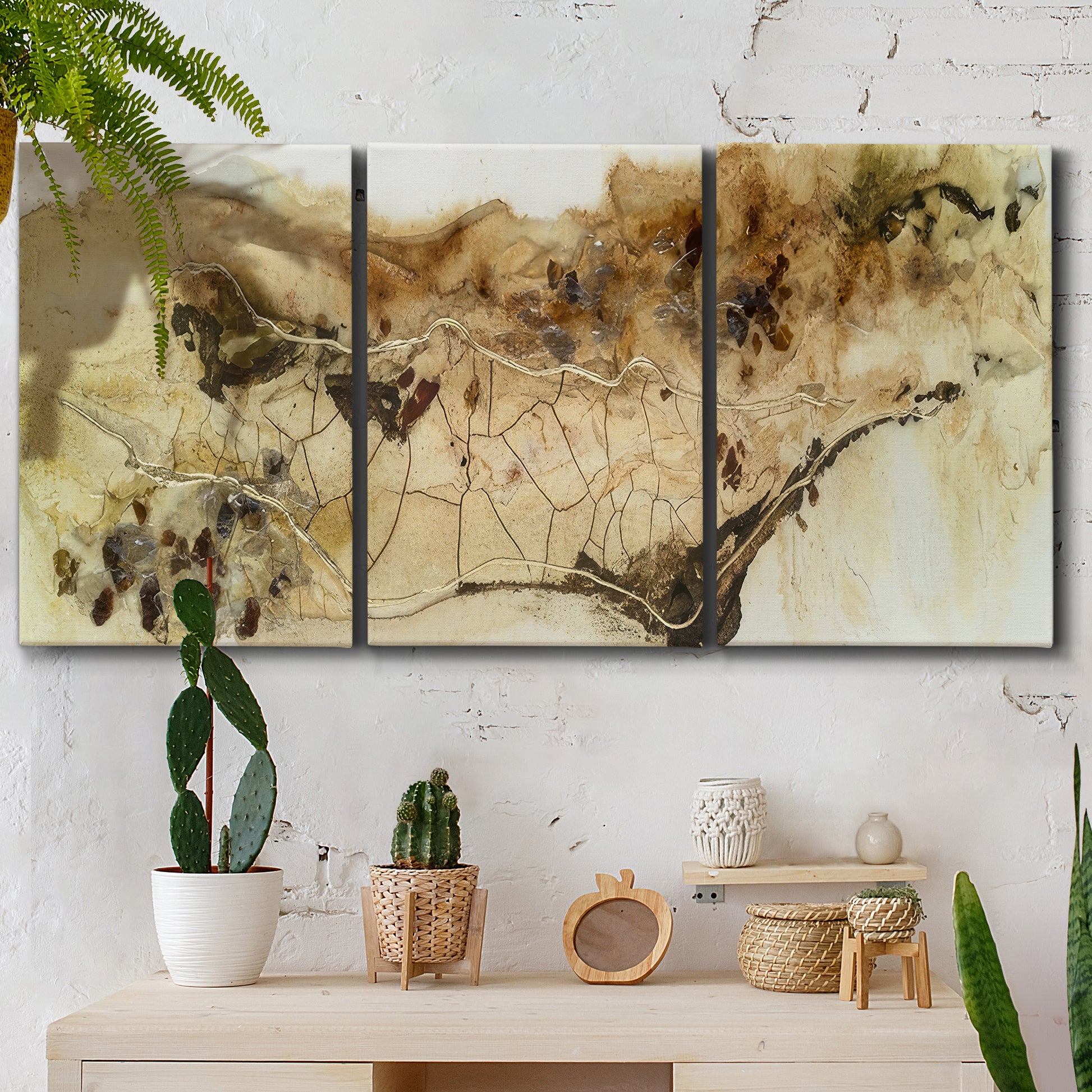 Three-panel canvas wall art featuring muted abstract with metallic gold accents, displayed in a boho-chic entryway above a console table.
