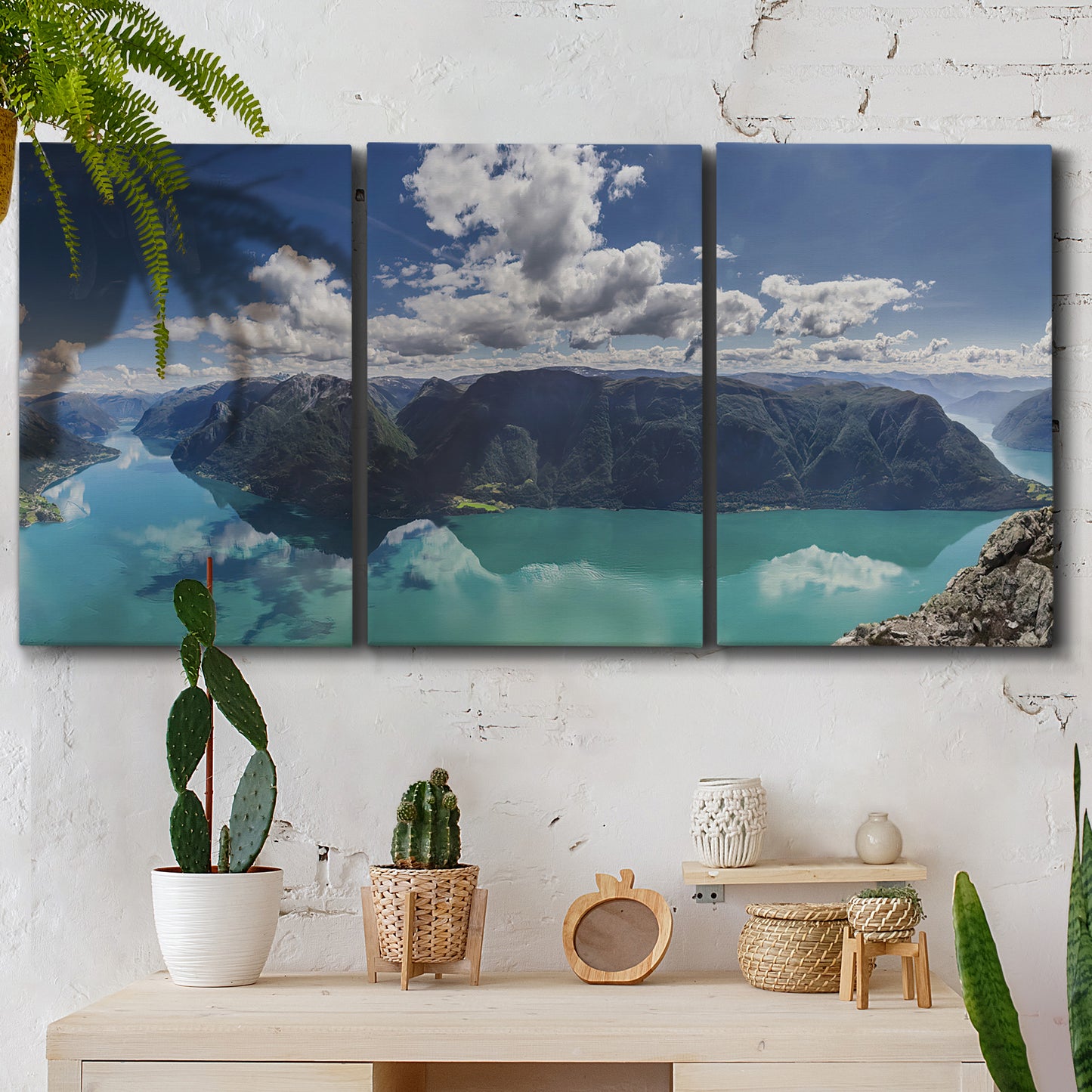 Three-panel canvas wall art featuring tropical water reflections with foliage, displayed in a boho-chic entryway above a console table.