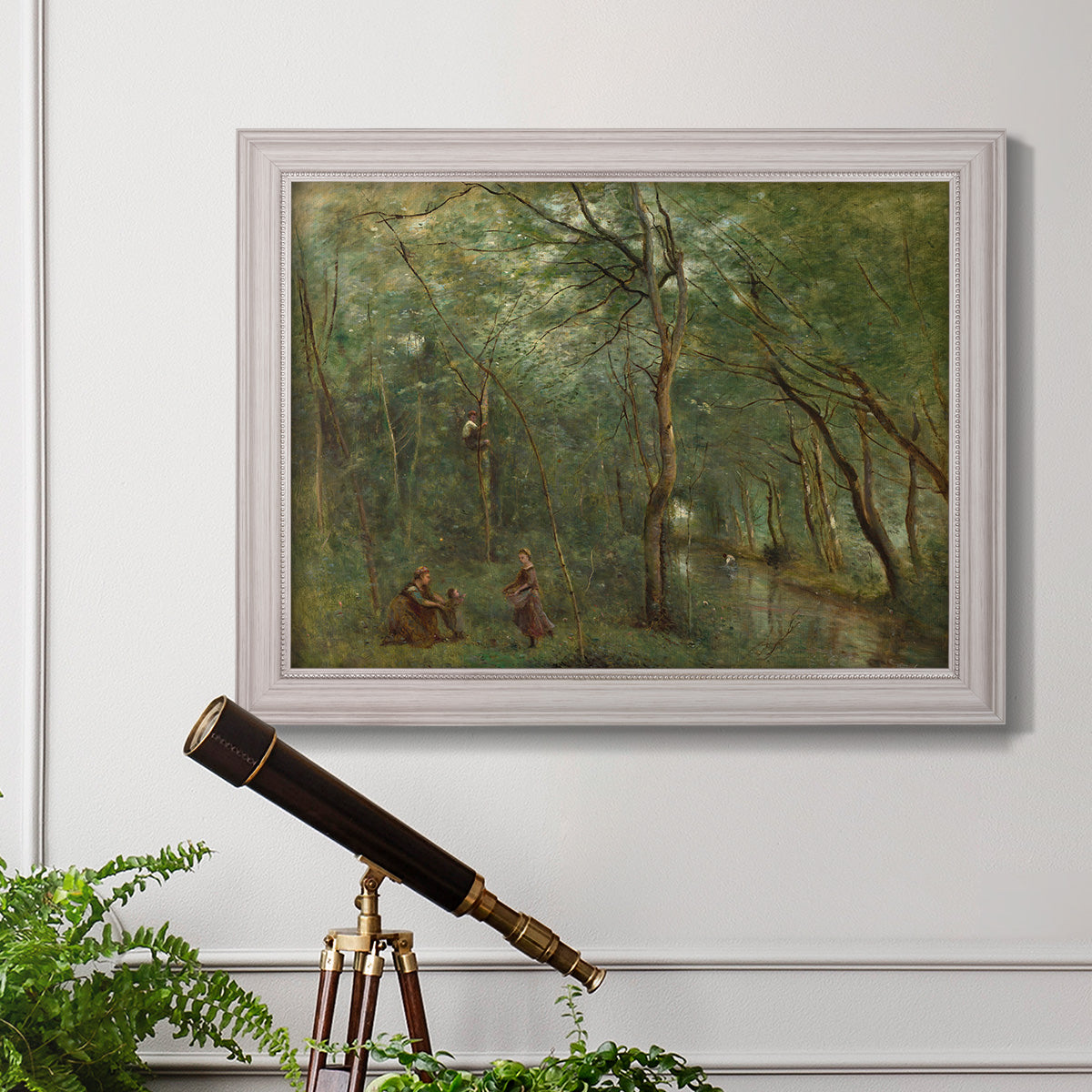 Traditional rural landscape scene with figures by Jean-Baptiste-Camille Corot in an ornate weathered white frame displayed in a light-toned interior setting.