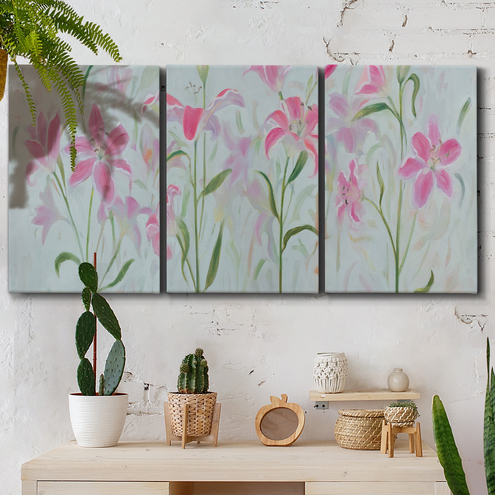 Three-panel canvas wall art featuring pink floral trio arrangement, displayed in a boho-chic entryway above a console table.