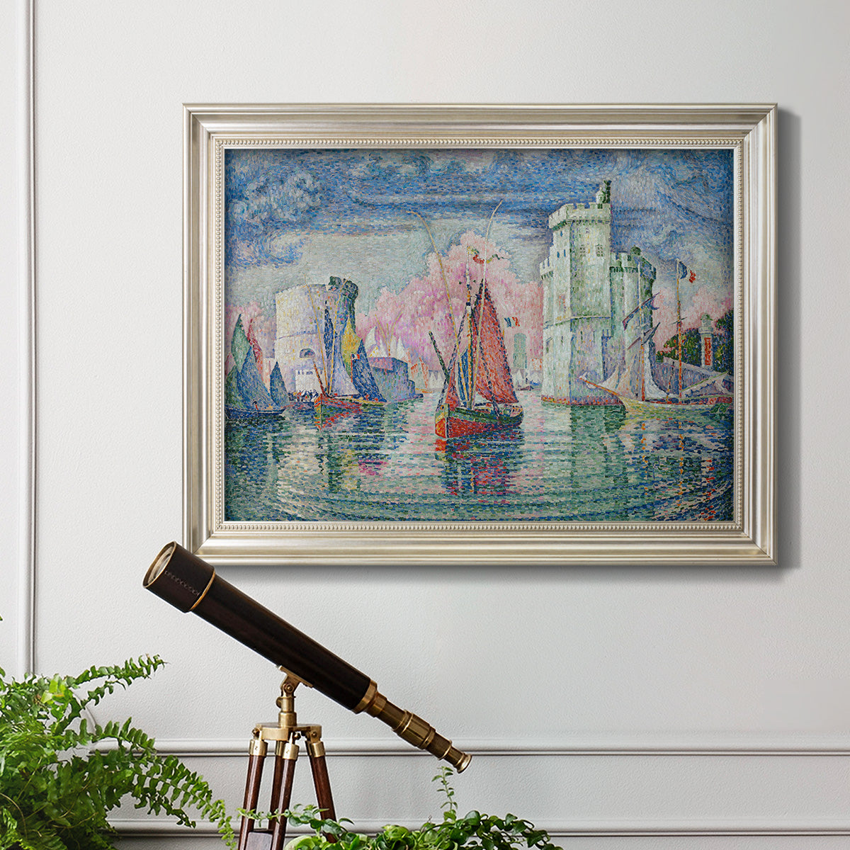 Impressionist harbor scene by Paul Signac in an ornate champagne frame displayed in a light-toned interior setting.