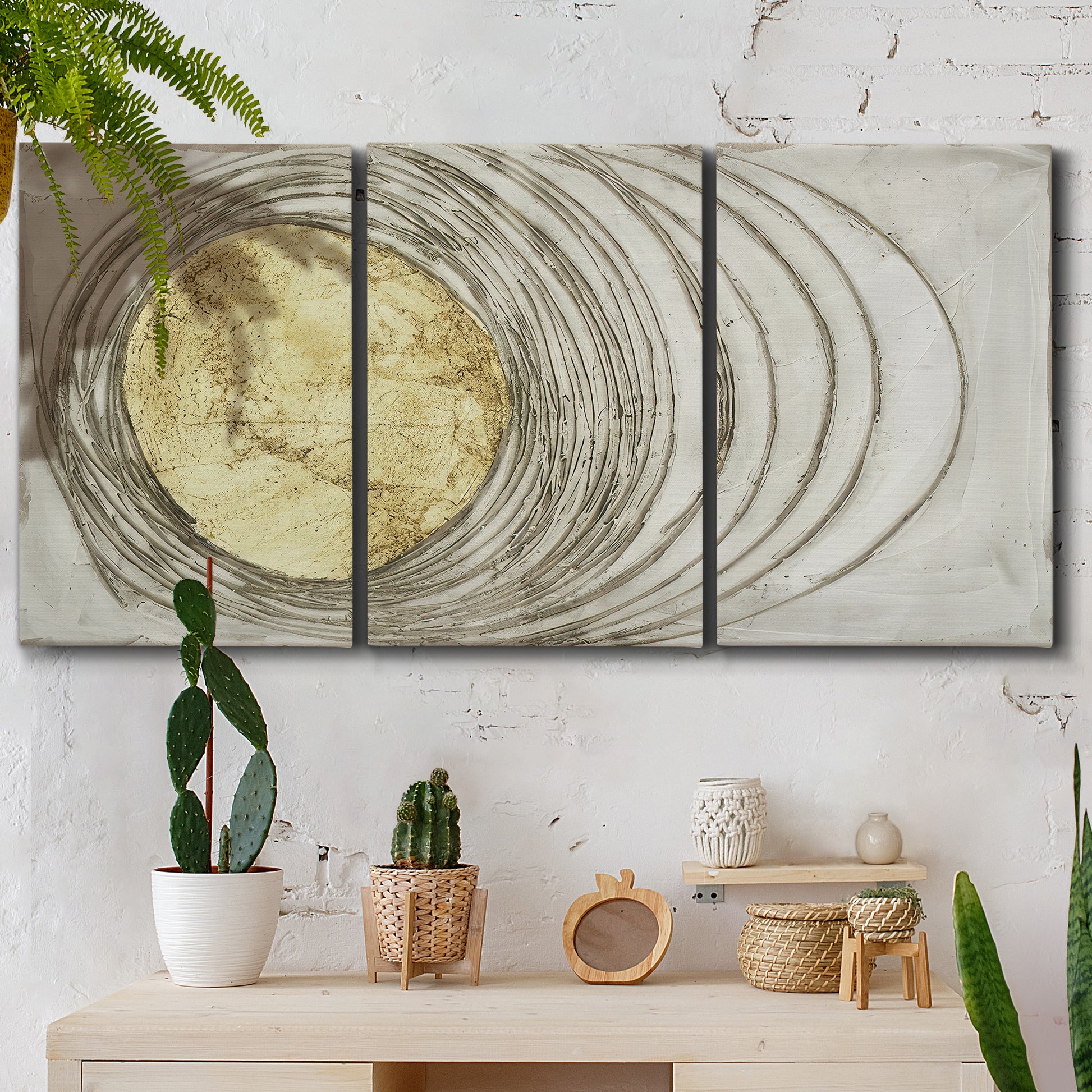 Three-panel canvas wall art featuring circular abstract energy forms, displayed in a boho-chic entryway above a console table.