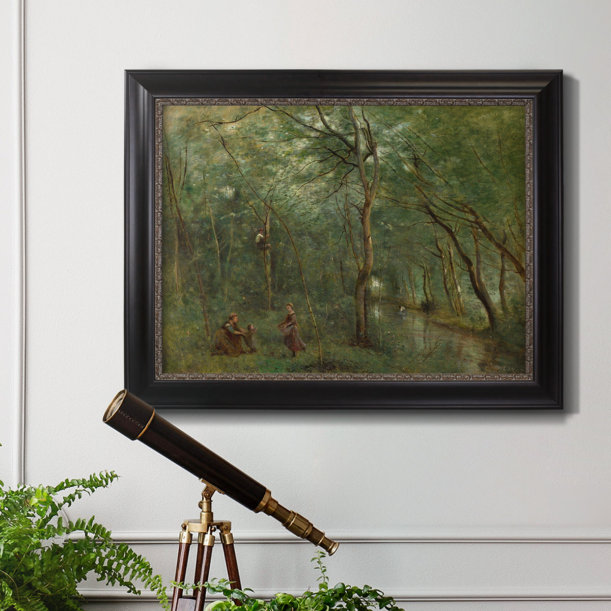 Traditional rural landscape scene with figures by Jean-Baptiste-Camille Corot in an ornate black frame with gilded inner detail displayed in a light-toned interior setting.