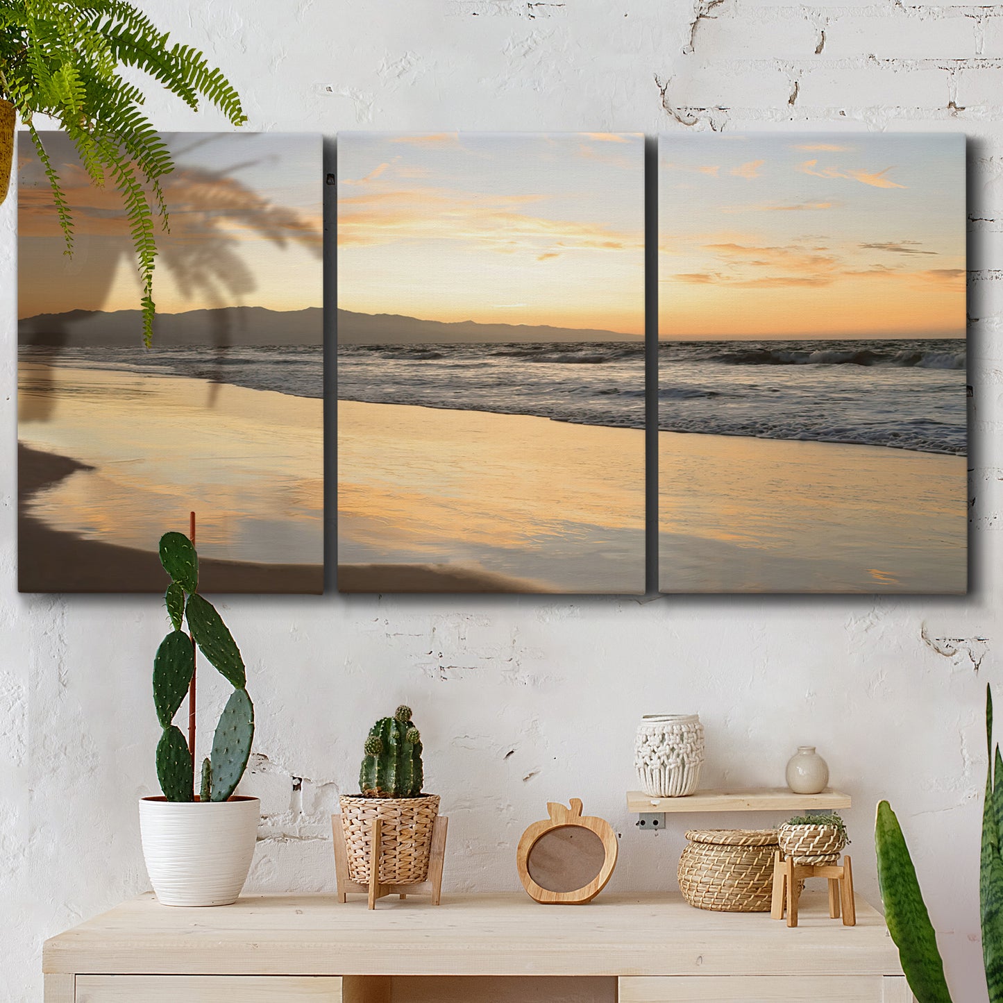 Three-panel canvas wall art featuring quiet tropical shoreline at low tide, displayed in a boho-chic entryway above a console table.