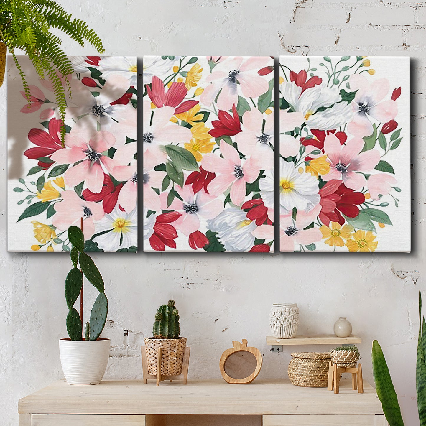 Three-panel canvas wall art featuring joyful spring floral composition, displayed in a boho-chic entryway above a console table.