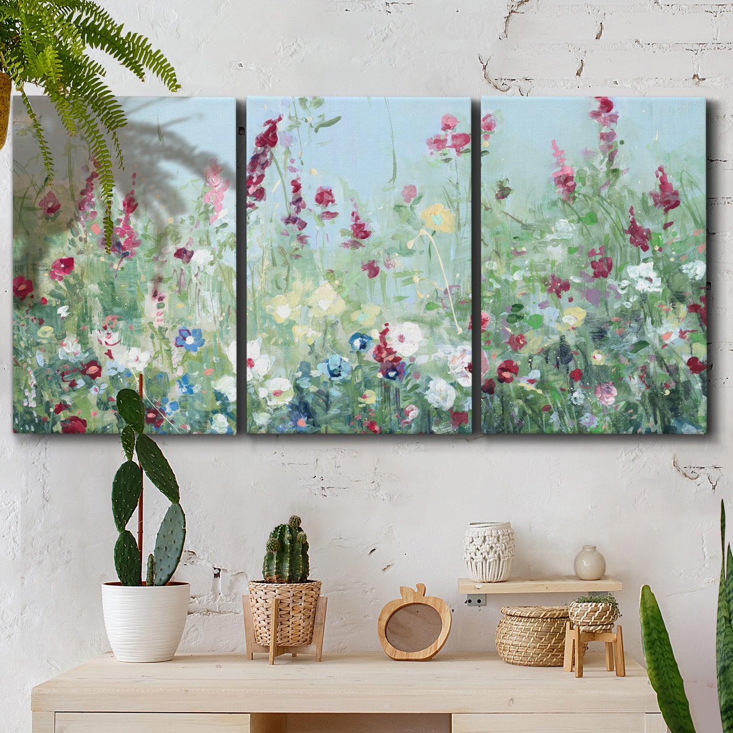 Three-panel canvas wall art featuring night landscape silhouette photography, displayed in a boho-chic entryway above a console table.
