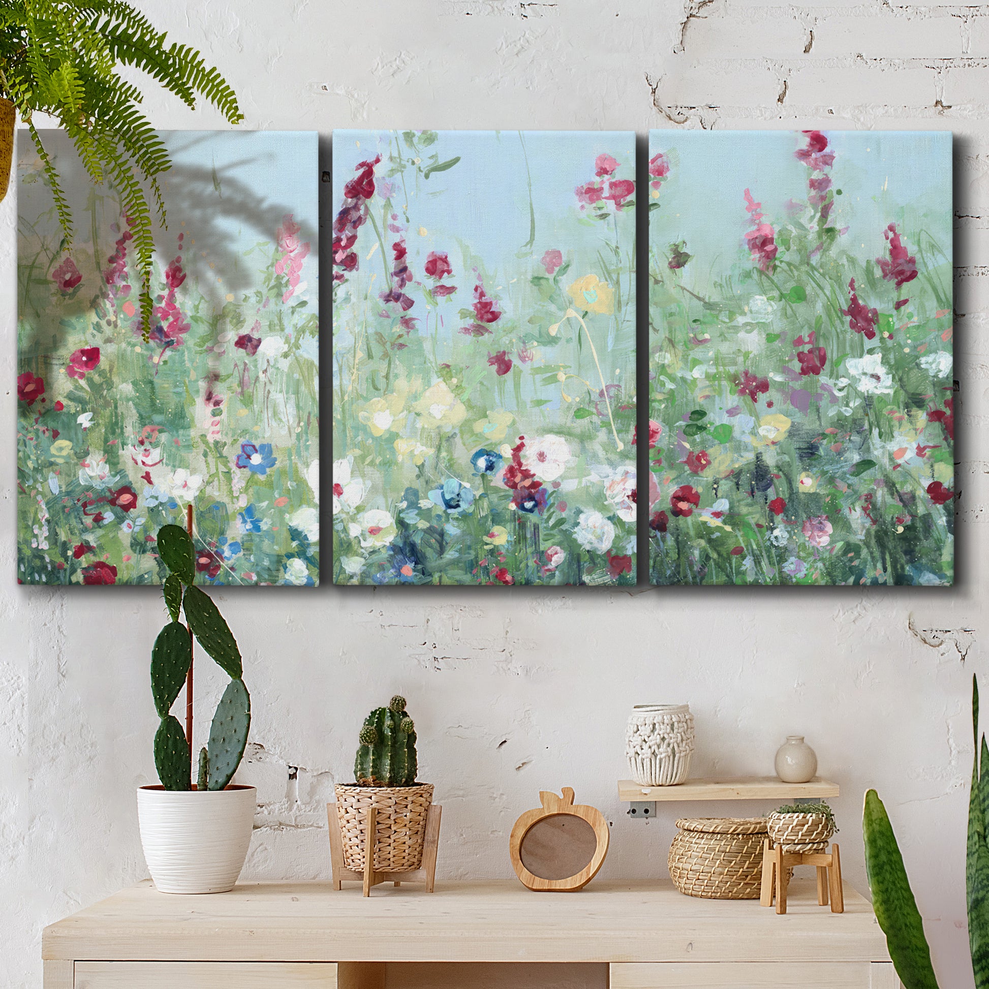Three-panel canvas wall art featuring night landscape silhouette photography, displayed in a boho-chic entryway above a console table.