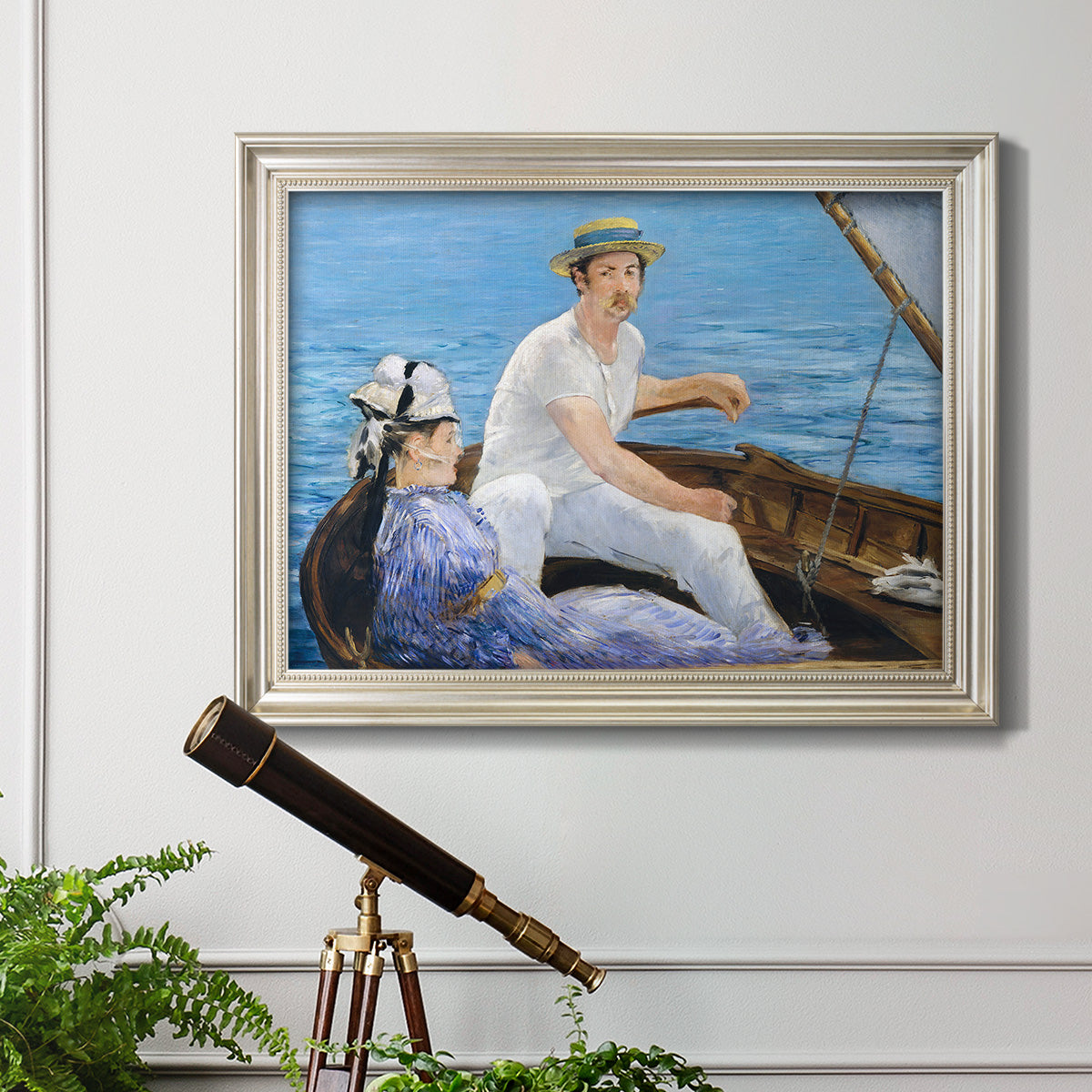 Impressionist leisure boating scene by Édouard Manet in an ornate champagne frame displayed in a light-toned interior setting.