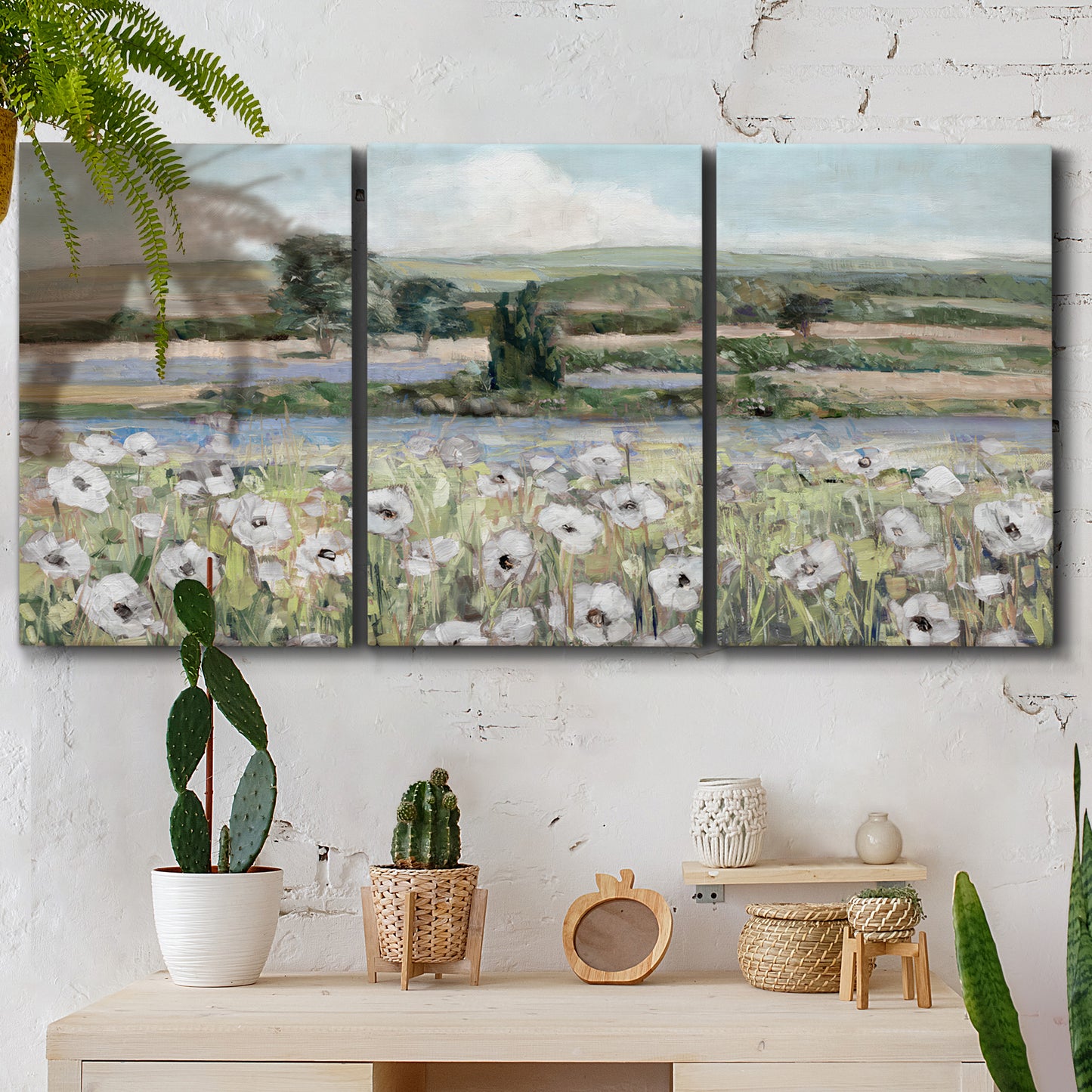 Three-panel canvas wall art featuring vintage poppy filled valley, displayed in a boho-chic entryway above a console table.