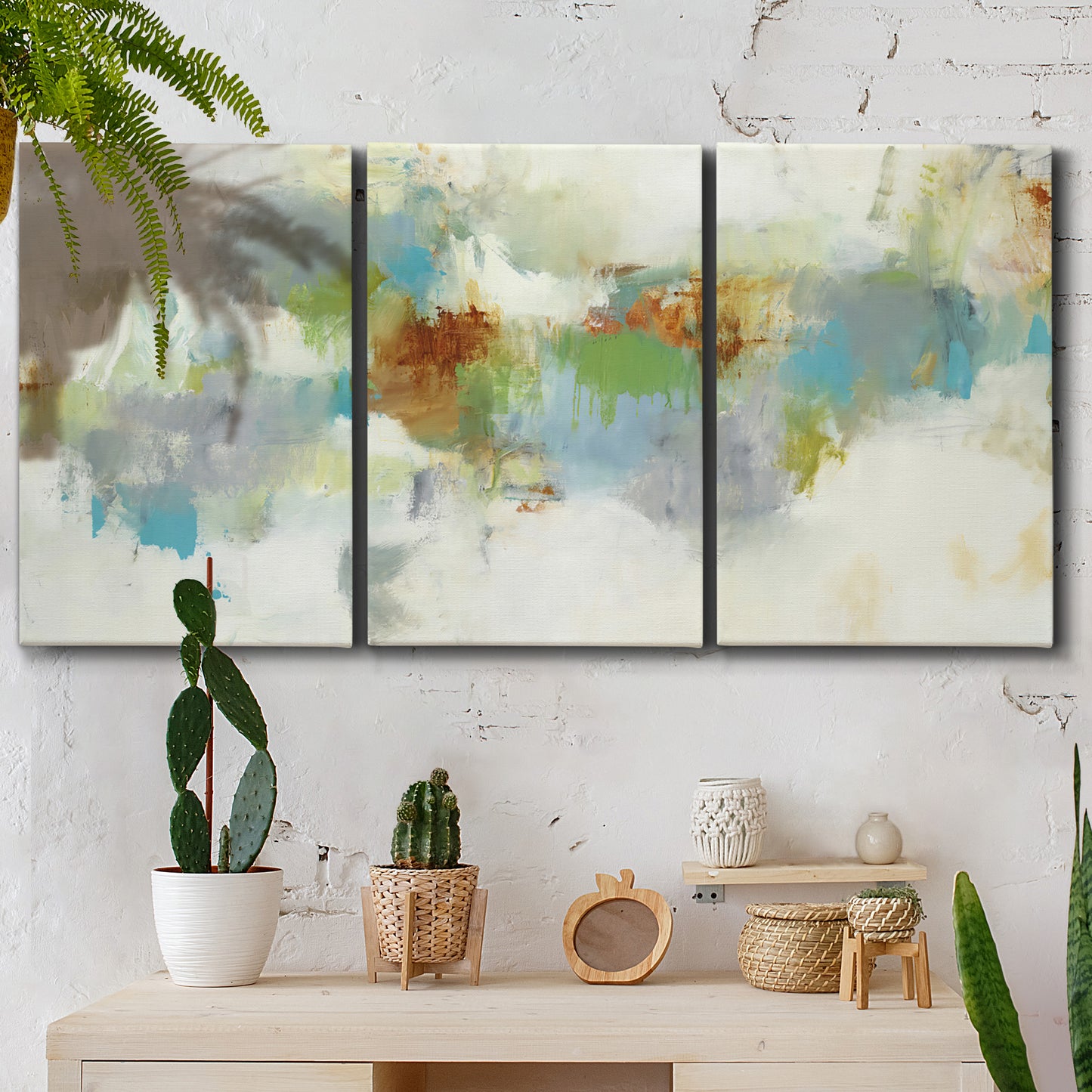 Three-panel canvas wall art featuring abstract suggestion of discovery, displayed in a boho-chic entryway above a console table.