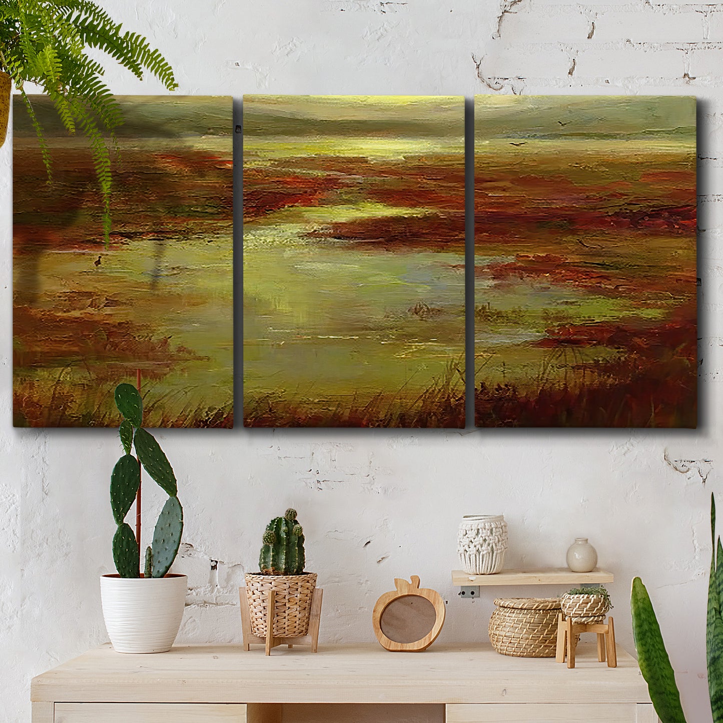 Three-panel canvas wall art featuring coastal shoreline with warm light, displayed in a boho-chic entryway above a console table.