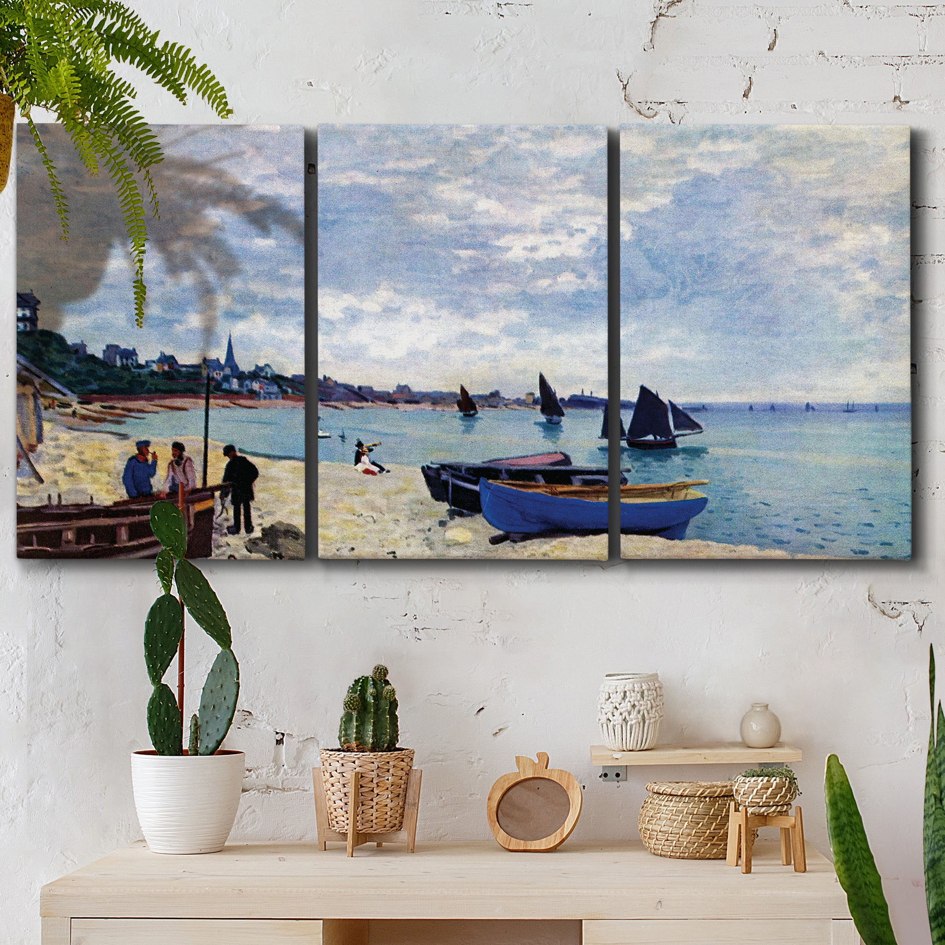 Three-panel canvas wall art featuring busy beach scene with shoreline, displayed in a boho-chic entryway above a console table.
