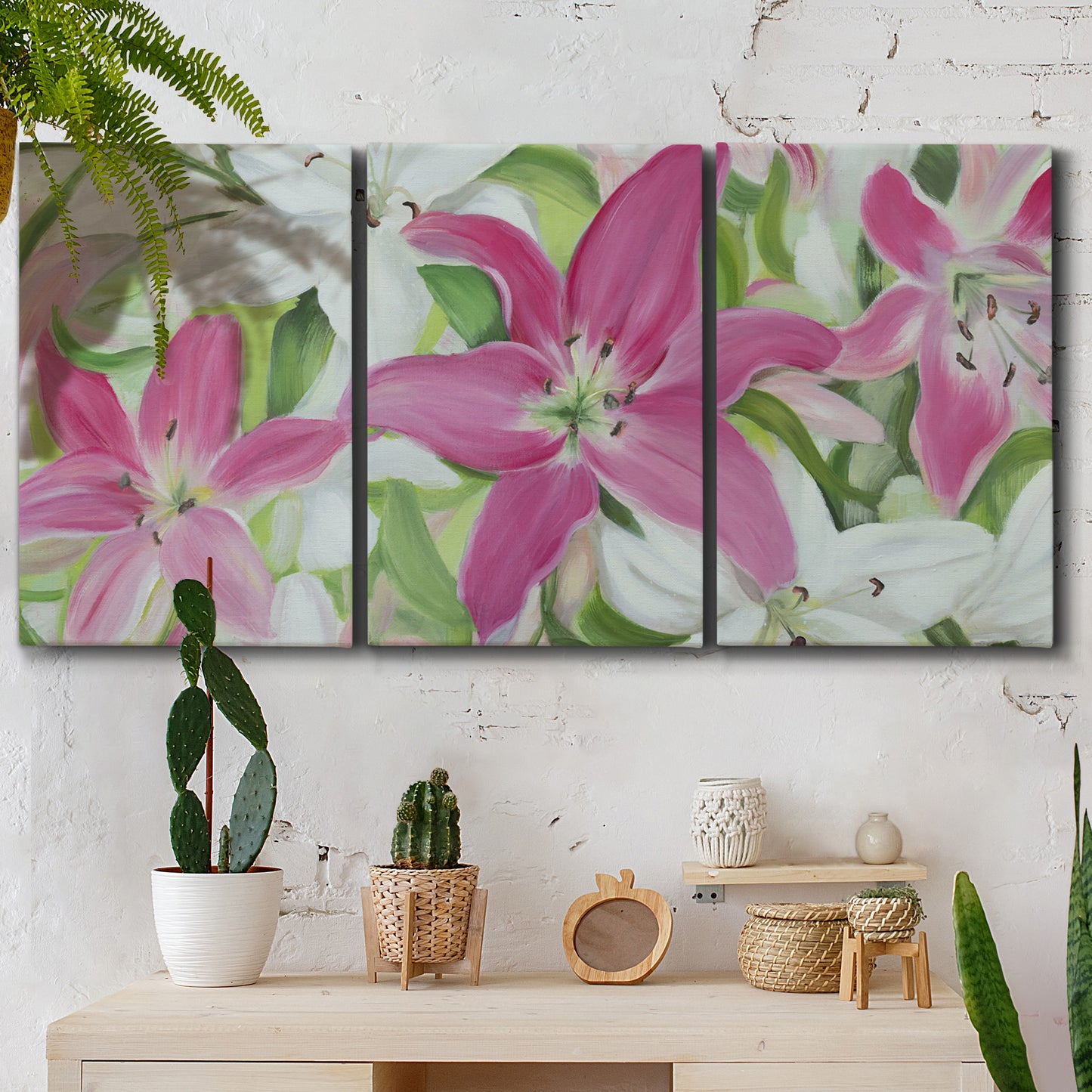 Three-panel canvas wall art featuring pink and white lilies in bloom, displayed in a boho-chic entryway above a console table.