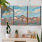 Three-panel canvas wall art featuring soft pastel western hills landscape, displayed in a boho-chic entryway above a console table.