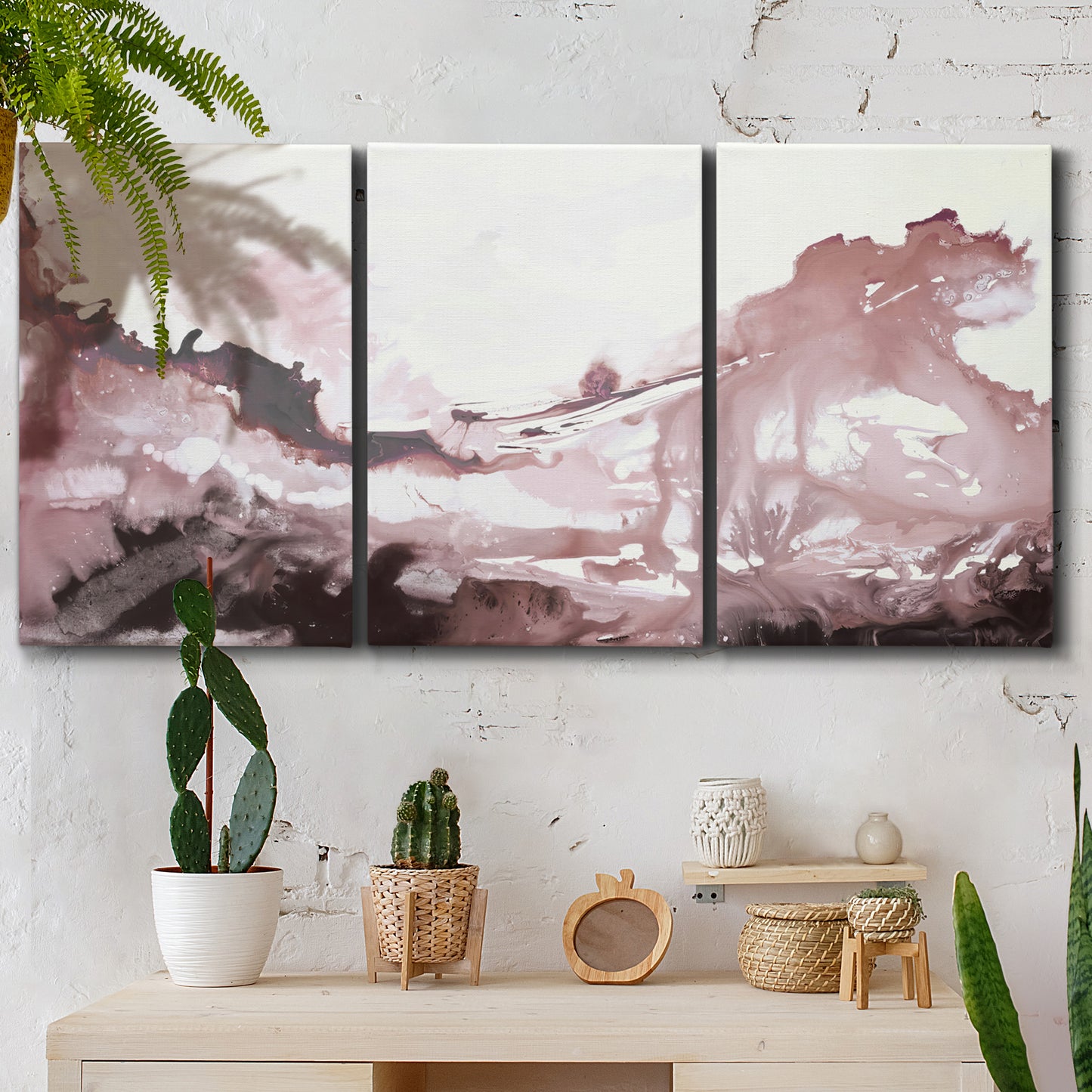 Three-panel canvas wall art featuring soft pink abstract scenic layers, displayed in a boho-chic entryway above a console table.