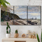 Three-panel canvas wall art featuring open sea along rocky shore, displayed in a boho-chic entryway above a console table.