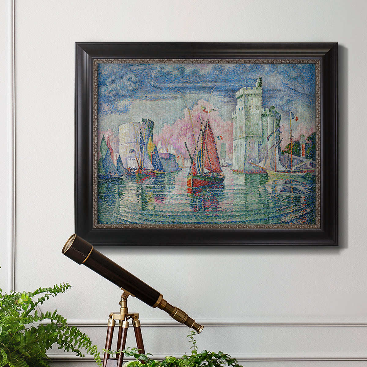 Impressionist harbor scene by Paul Signac in an ornate black frame with gilded inner detail displayed in a light-toned interior setting.