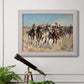 Impressionist western action scene by Frederic Remington in an ornate weathered white frame displayed in a light-toned interior setting.