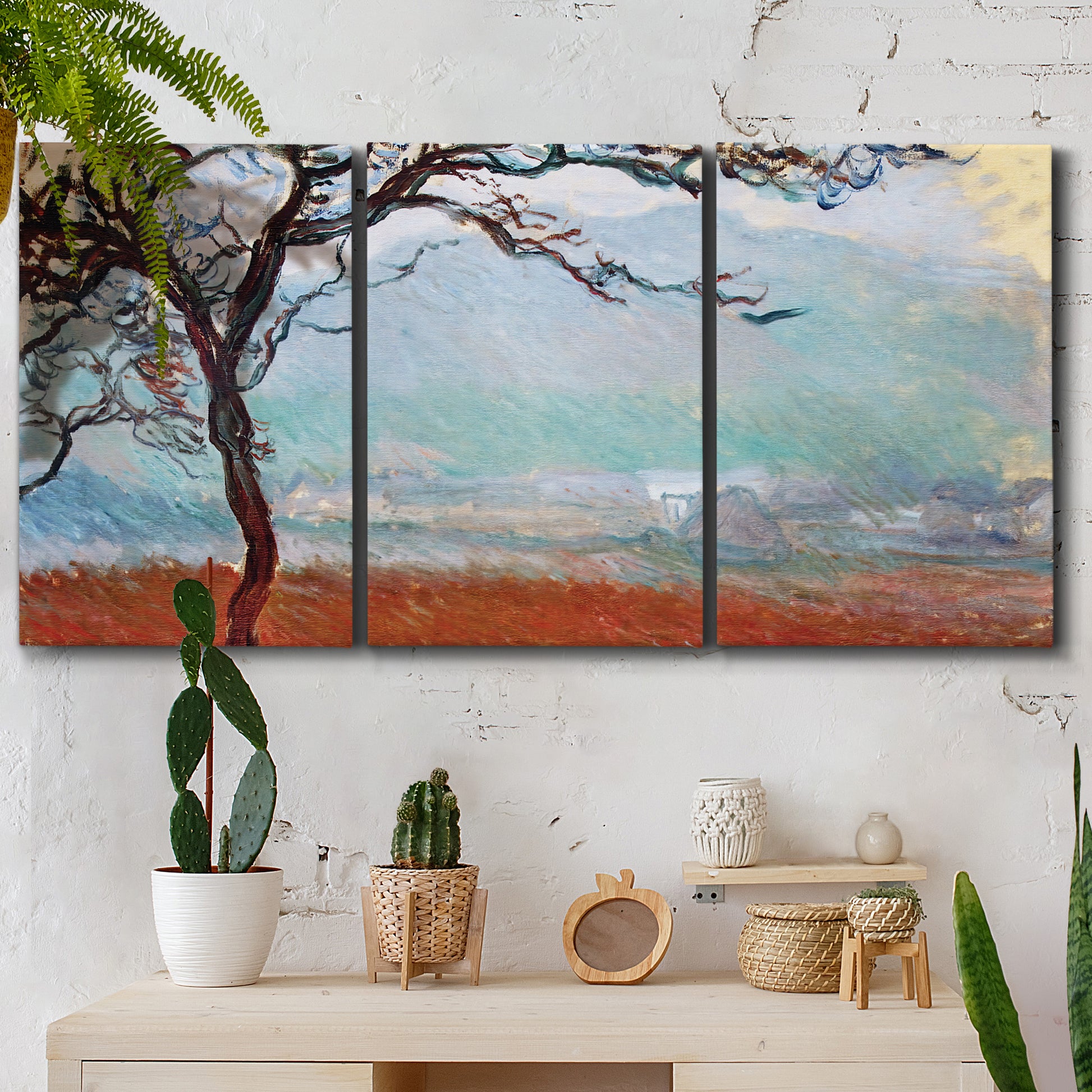 Three-panel canvas wall art featuring coastal trees at evening light, displayed in a boho-chic entryway above a console table.