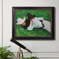 Impressionist outdoor portrait of two girls by John Singer Sargent in an ornate black frame with gilded inner detail displayed in a light-toned interior setting.