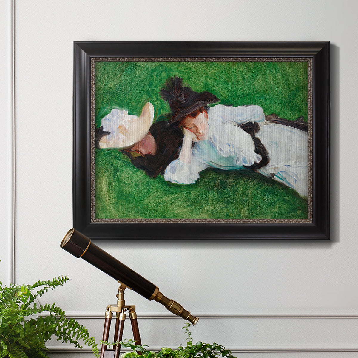 Impressionist outdoor portrait of two girls by John Singer Sargent in an ornate black frame with gilded inner detail displayed in a light-toned interior setting.