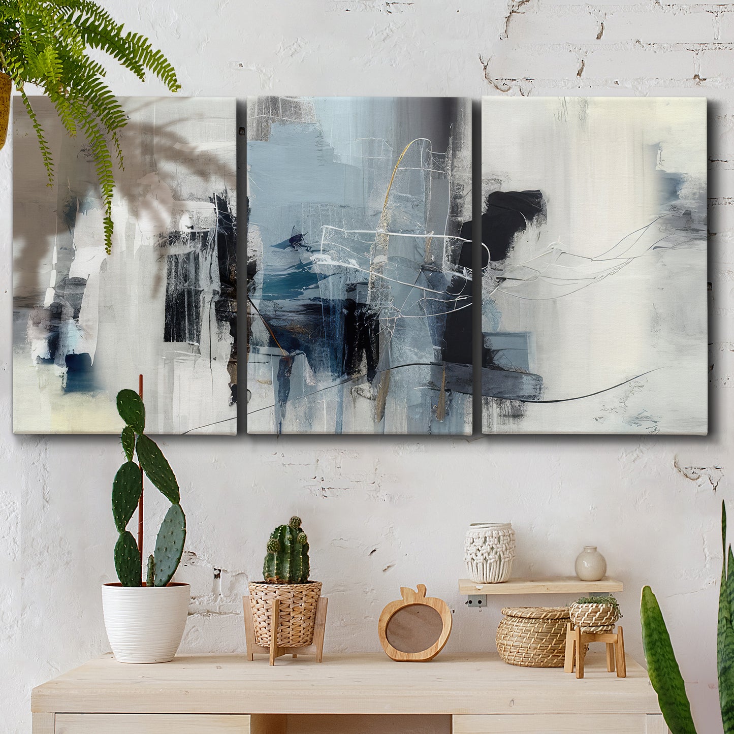 Three-panel canvas wall art featuring cool abstract winter color wash, displayed in a boho-chic entryway above a console table.
