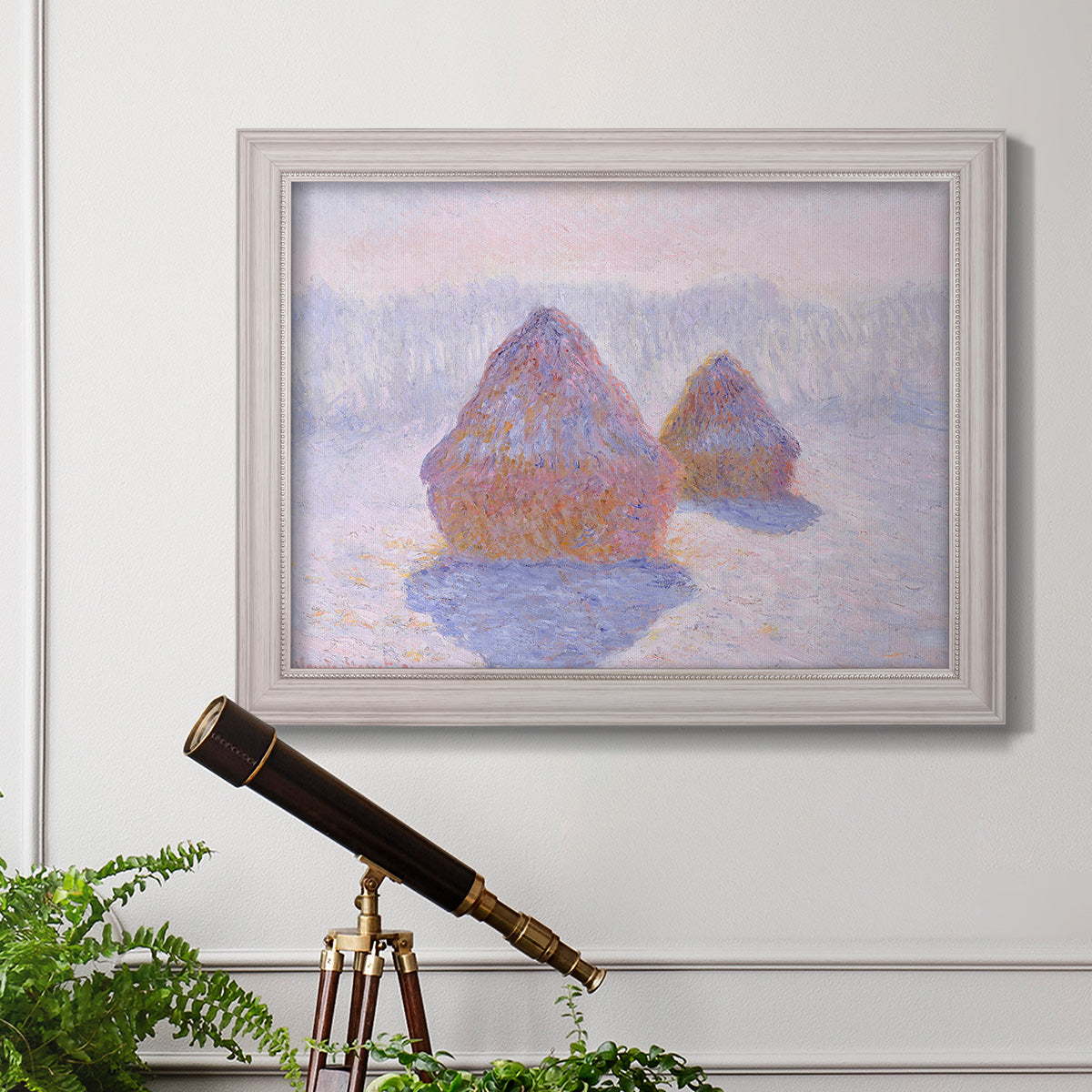 Impressionist winter haystack scene with sunlight by Claude Monet in an ornate weathered white frame displayed in a light-toned interior setting.