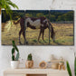Three-panel canvas wall art featuring horses standing near farmhouse, displayed in a boho-chic entryway above a console table.