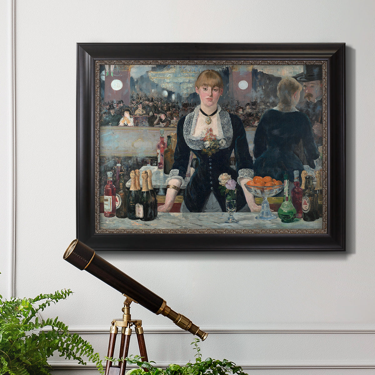 Iconic impressionist café bar scene by Édouard Manet in an ornate black frame with gilded inner detail displayed in a light-toned interior setting.
