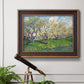 Impressionist spring orchard landscape by Vincent van Gogh in an ornate bronzed mahogany wood frame displayed in a light-toned interior setting.