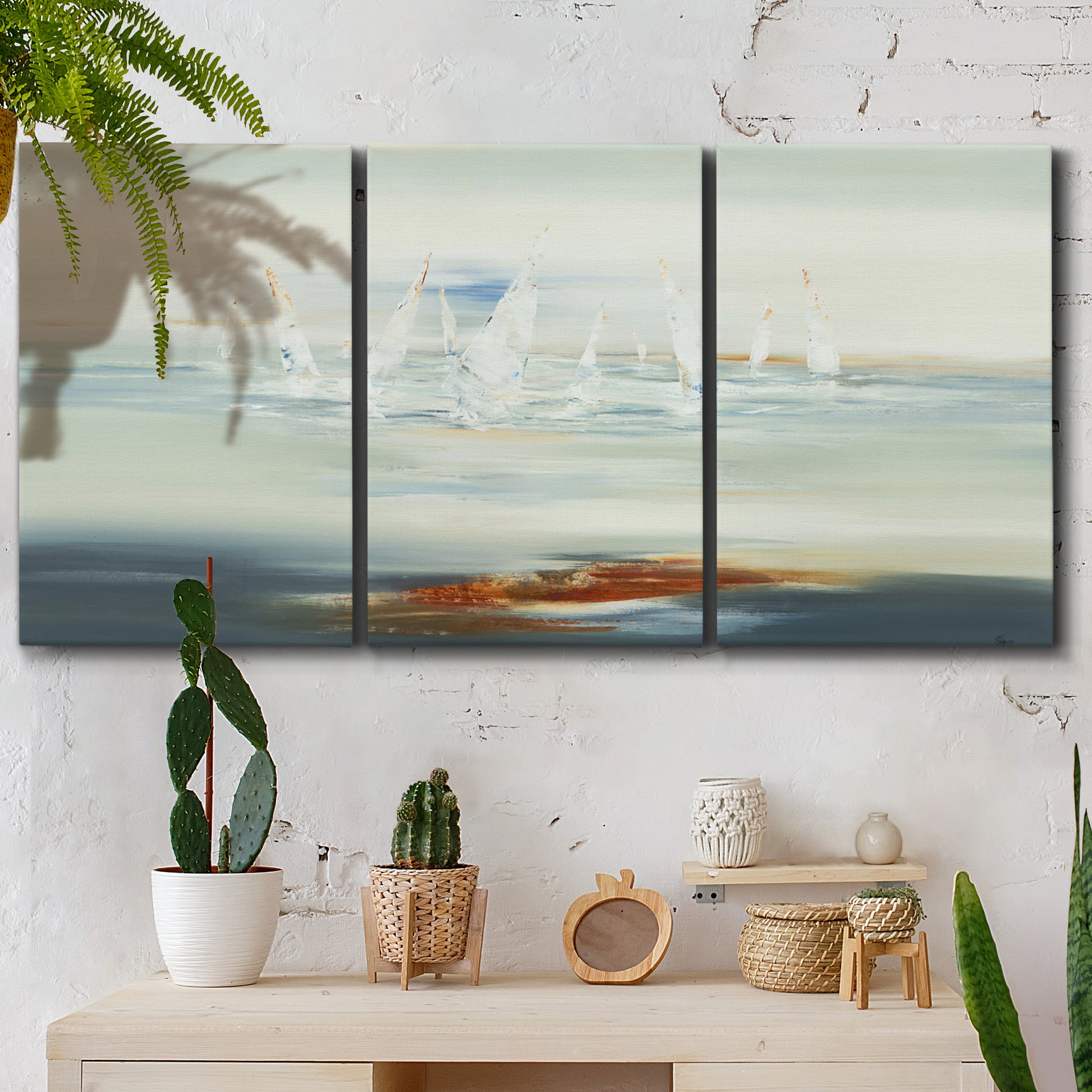 Three-panel canvas wall art featuring nautical abstract suggesting drifting calm, displayed in a boho-chic entryway above a console table.