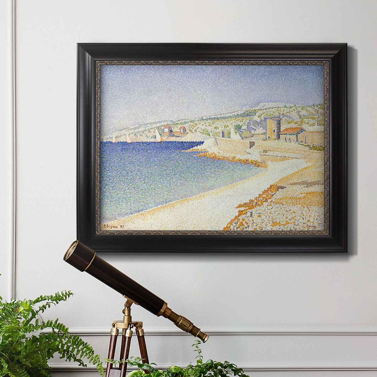 Impressionist Mediterranean jetty seascape by Paul Signac in an ornate black frame with gilded inner detail displayed in a light-toned interior setting.