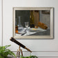 Impressionist still life with wine and bread by Claude Monet in an ornate champagne frame displayed in a light-toned interior setting.
