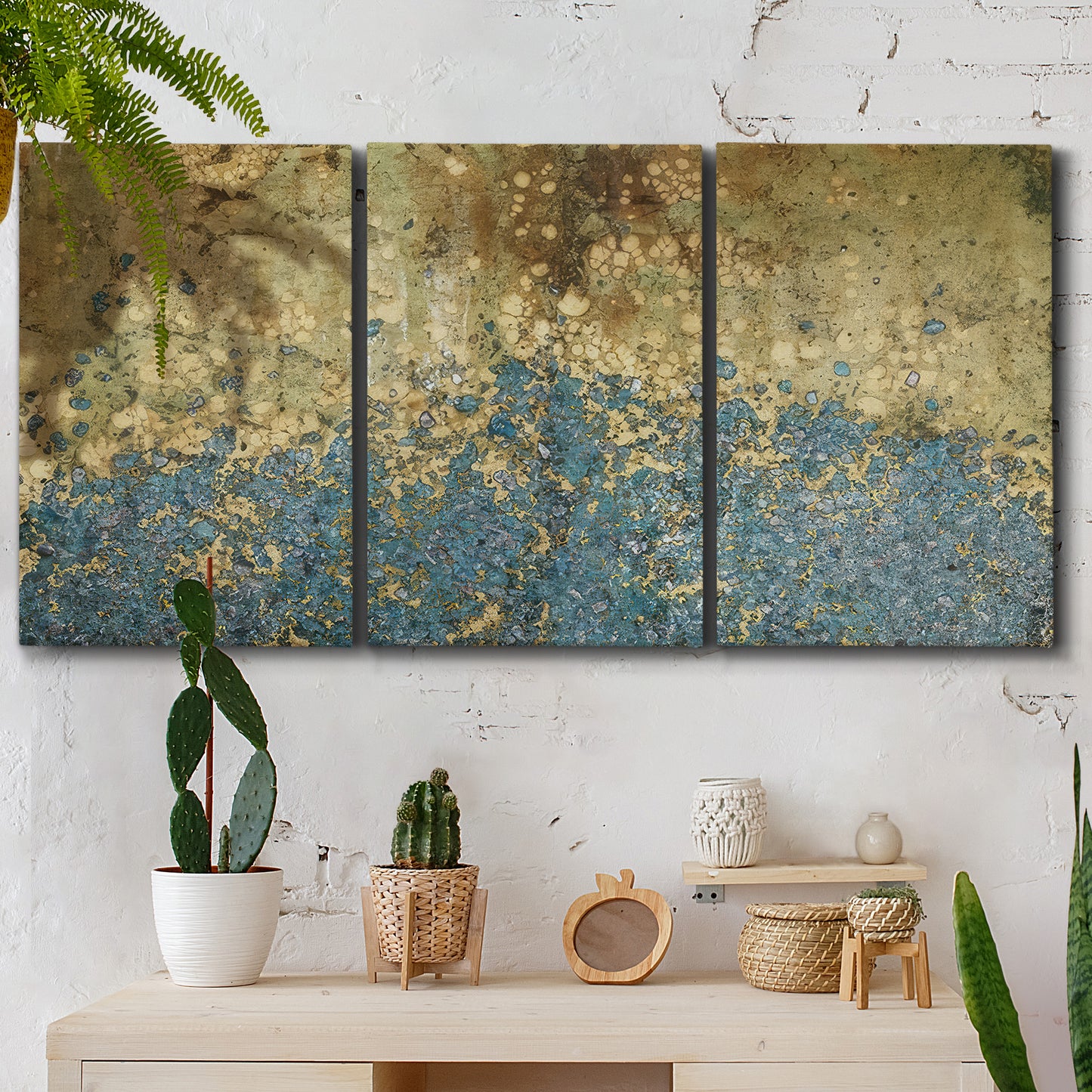 Three-panel canvas wall art featuring metallic abstract gold tones, displayed in a boho-chic entryway above a console table.