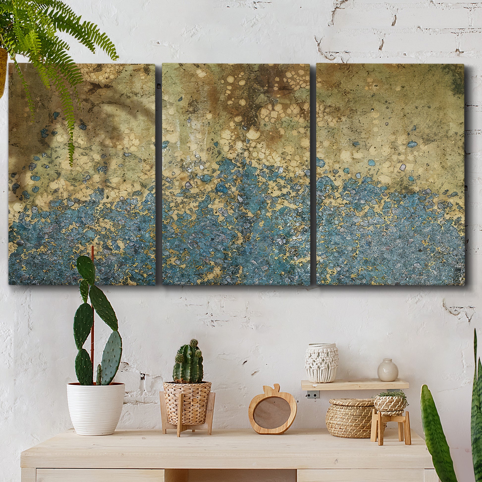 Three-panel canvas wall art featuring metallic abstract gold tones, displayed in a boho-chic entryway above a console table.