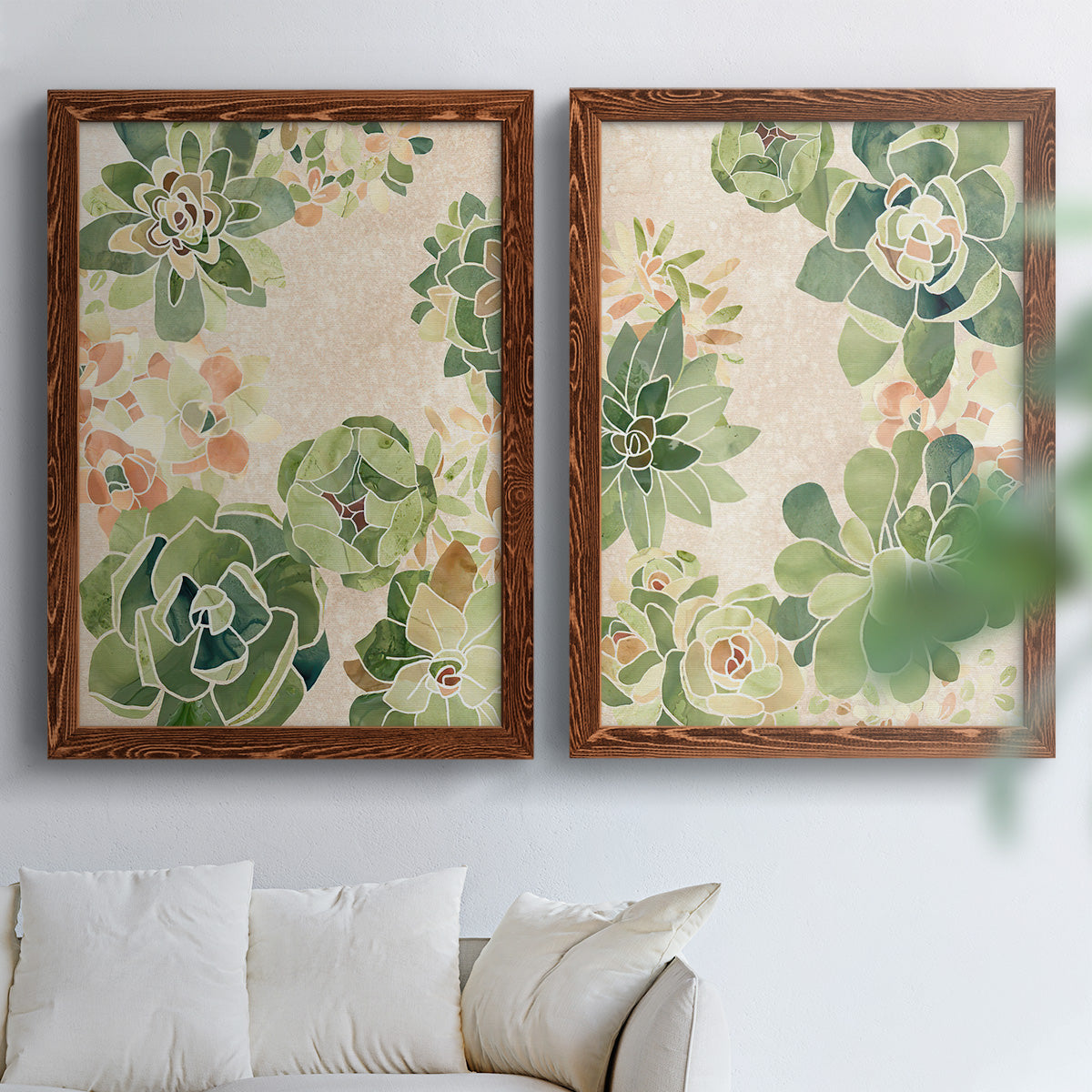 Set of two maple barnwood framed canvas prints depicting green rosettes, peach blossoms, and mosaic-like outlines arranged across two complementary compositions above a sofa in a bright living space.