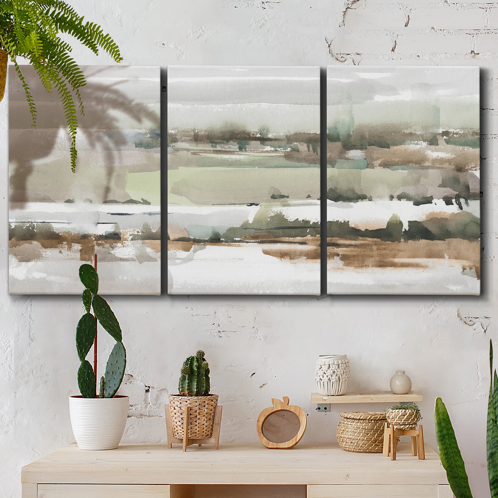 Three-panel canvas wall art featuring layered turquoise and earth tones abstract, displayed in a boho-chic entryway above a console table.