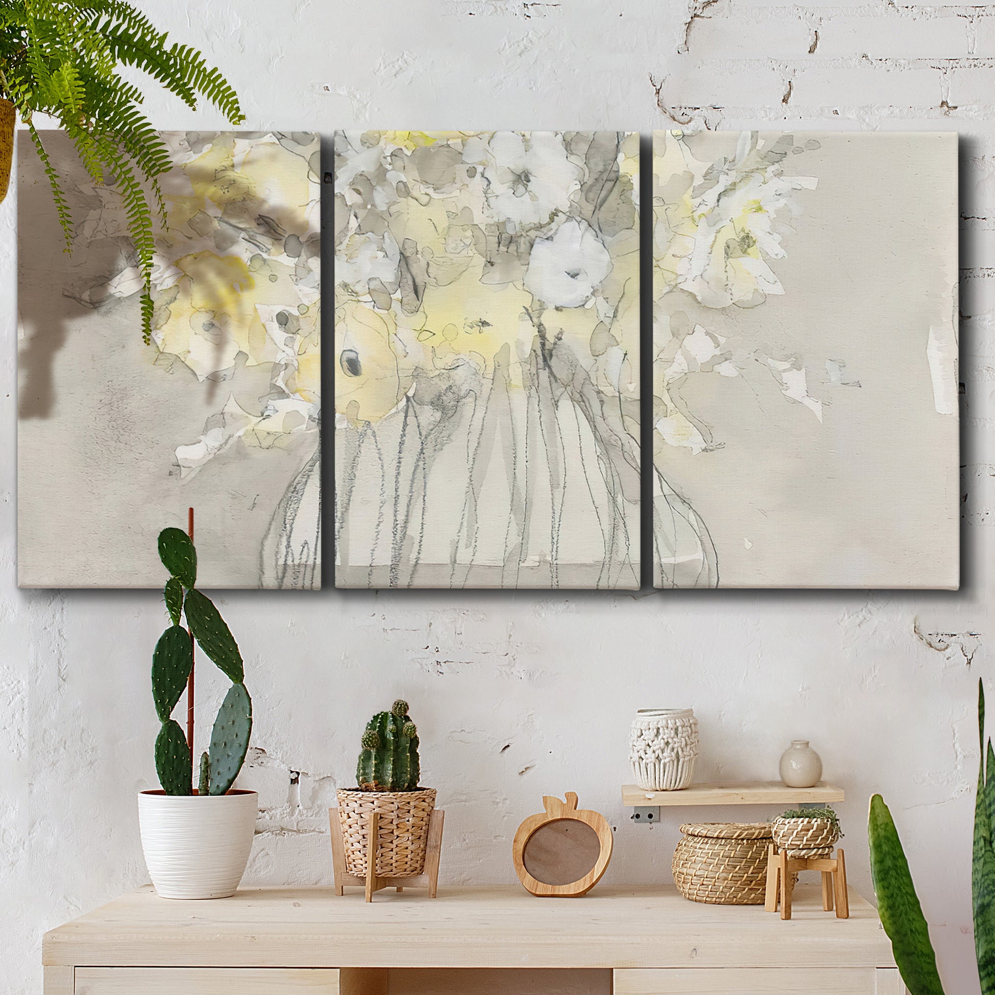 Three-panel canvas wall art featuring vintage floral abstract composition, displayed in a boho-chic entryway above a console table.