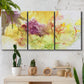 Three-panel canvas wall art featuring abstract floral rhythm composition, displayed in a boho-chic entryway above a console table.