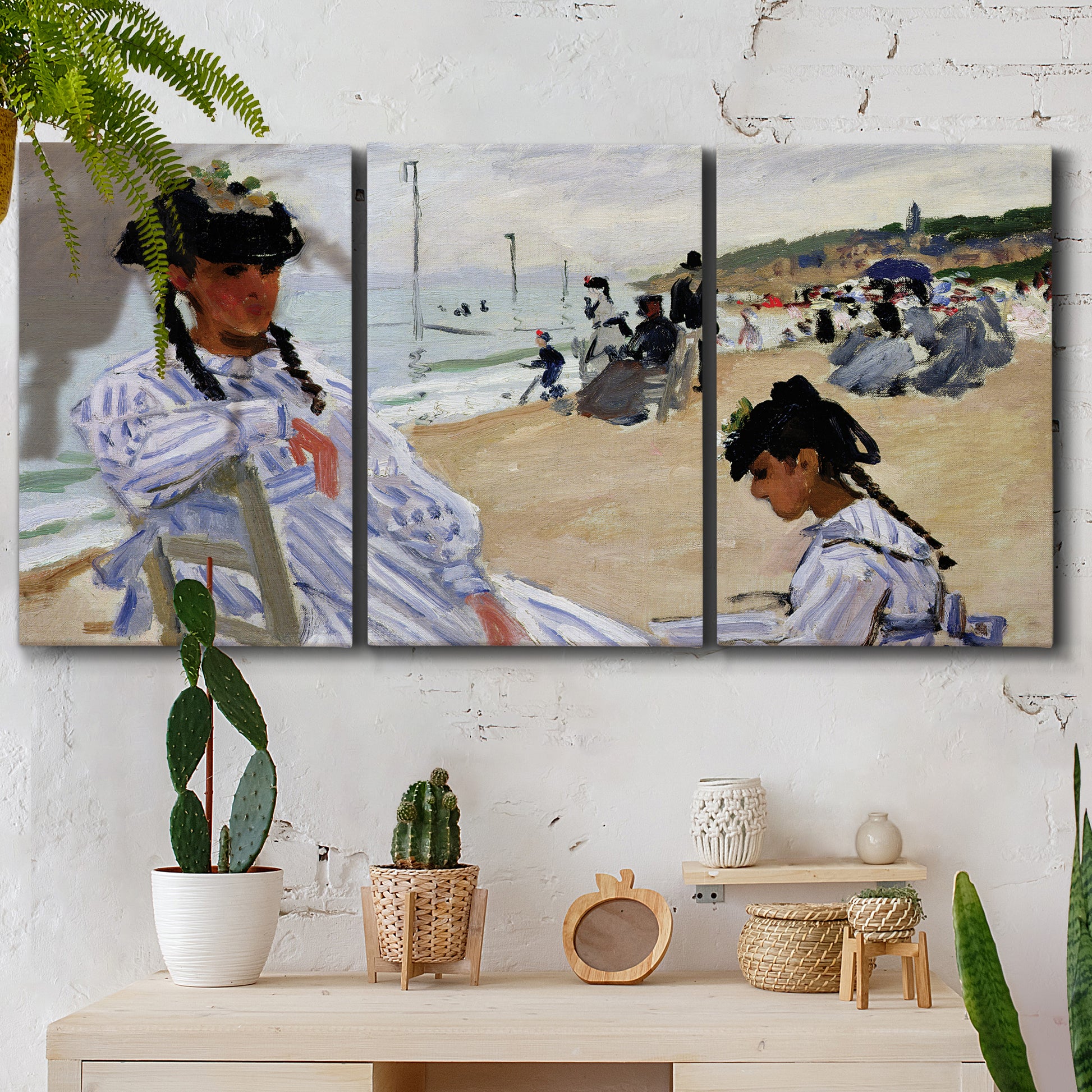 Three-panel canvas wall art featuring figures walking along sandy beach, displayed in a boho-chic entryway above a console table.