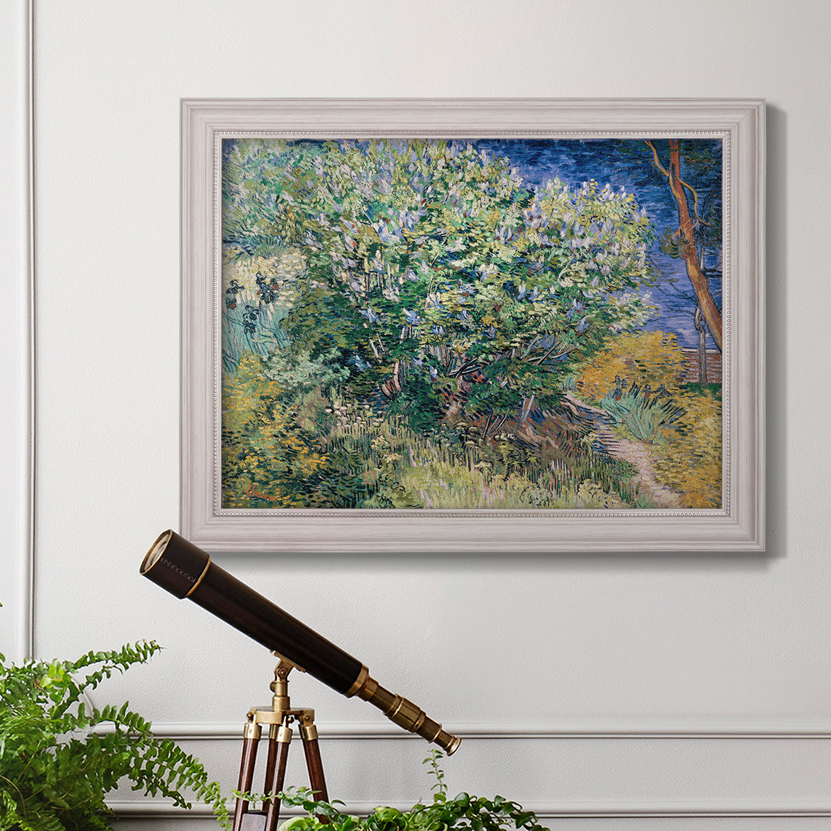 Impressionist lilac flower painting by Vincent van Gogh in an ornate weathered white frame displayed in a light-toned interior setting.