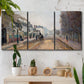 Three-panel canvas wall art featuring tree lined boulevard in town, displayed in a boho-chic entryway above a console table.
