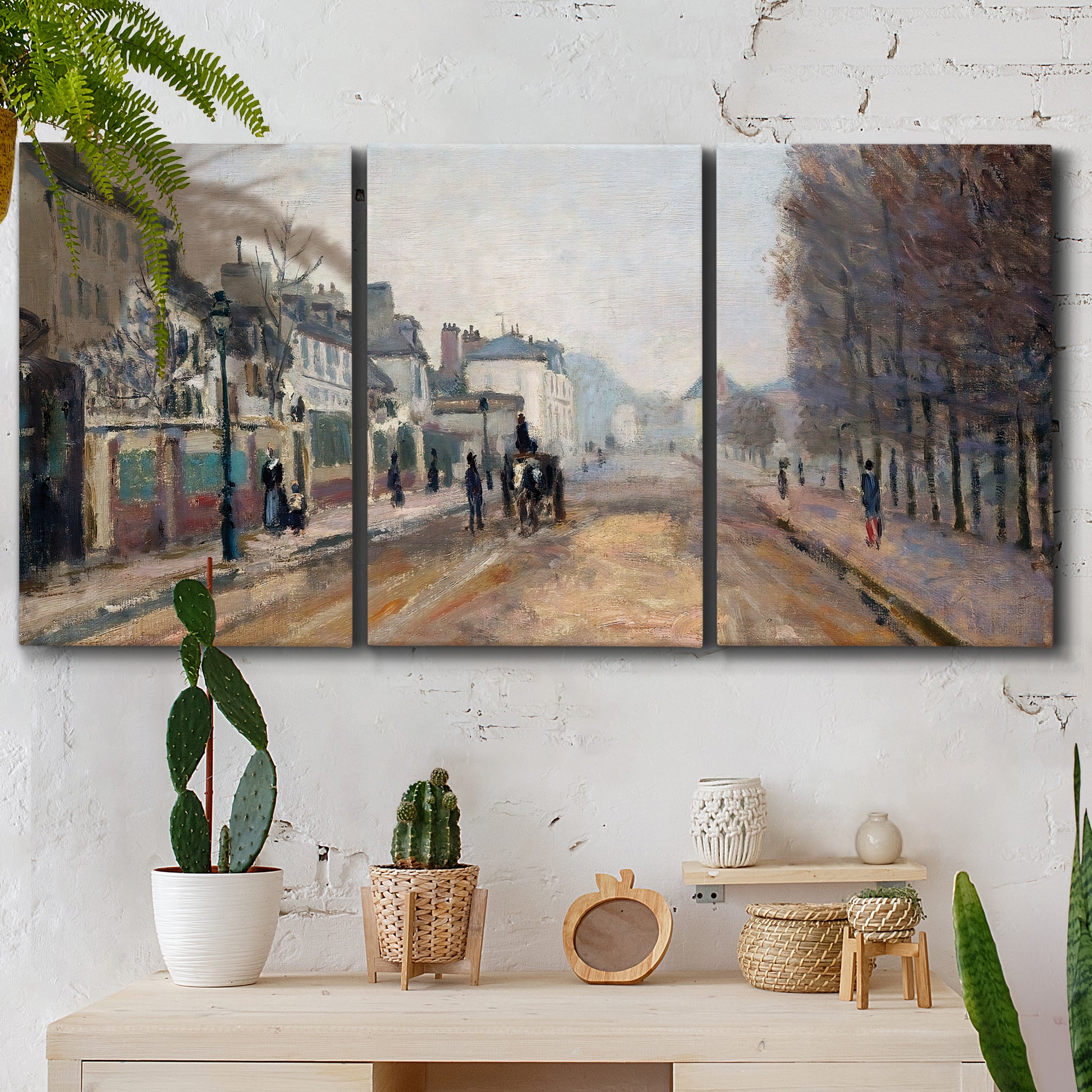 Three-panel canvas wall art featuring tree lined boulevard in town, displayed in a boho-chic entryway above a console table.